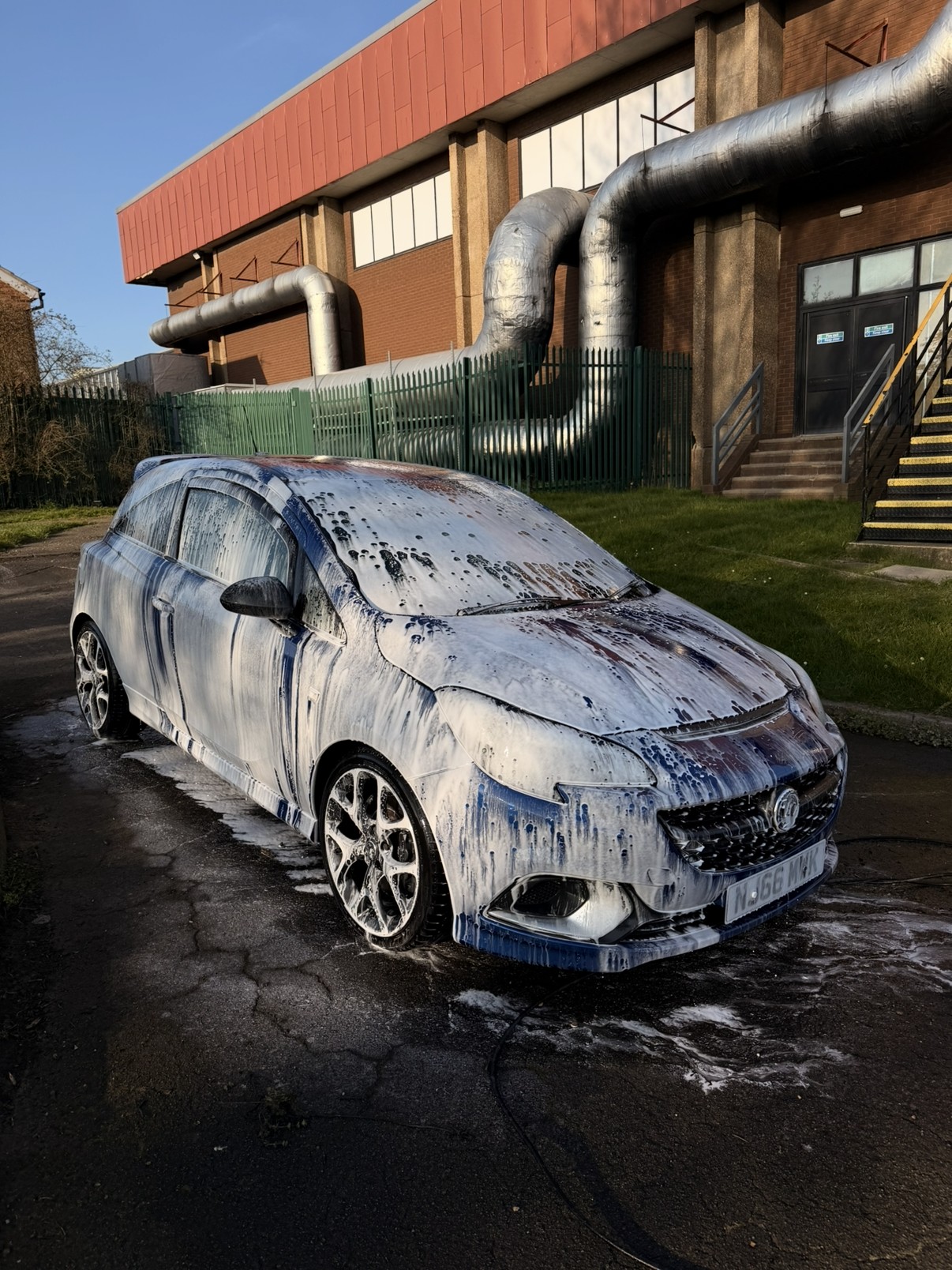 Vauxhall Corsa VXR covered in snow foam during a wash